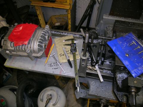 1995 Ford Probe - Supercharger and machining tools are laid out on a workbench, ready for work.
