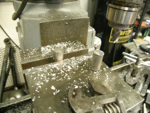 1995 Ford Probe - A close-up view of a milling machine with metal parts and shavings.