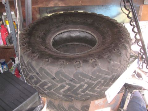1968 Ford Mustang - A large off-road tire, possibly for a truck or SUV, is shown in a garage setting.