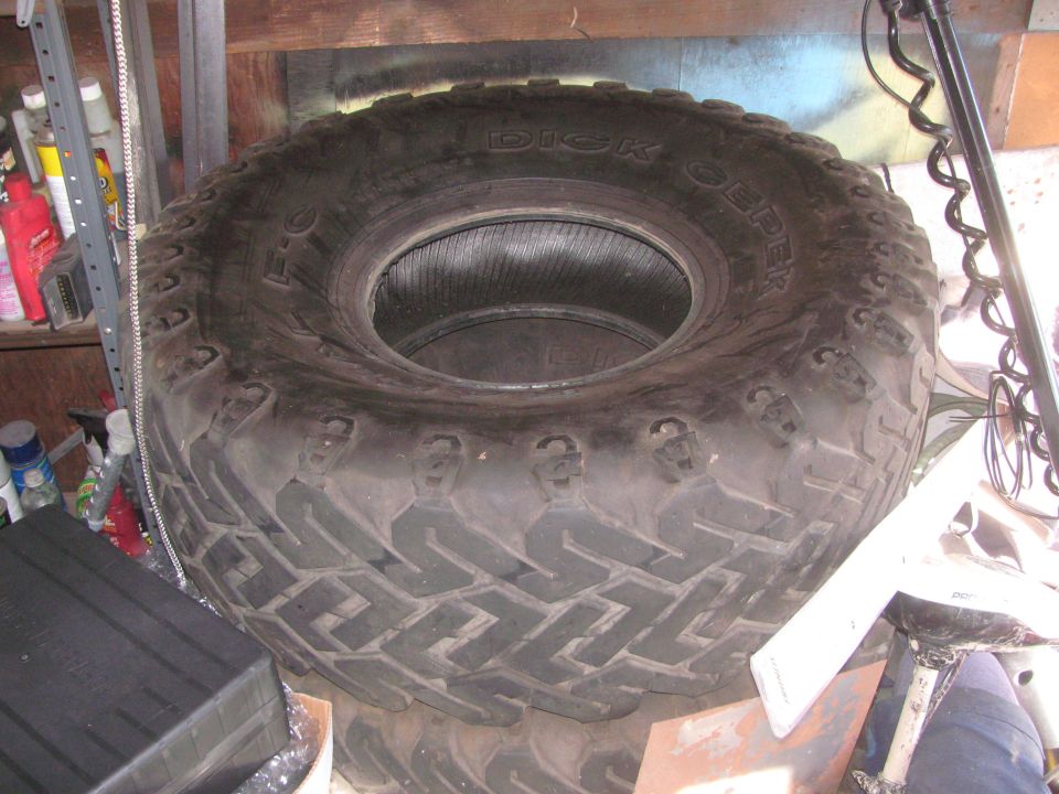 Large off-road tire with 'Dick Cepek' text visible on sidewall