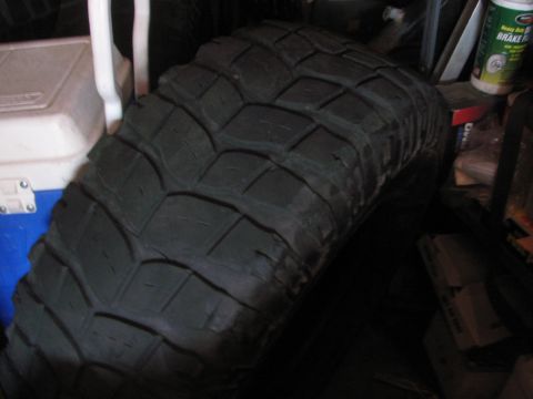 1968 Ford Mustang - A single off-road tire is shown leaning against a cooler in a storage area.