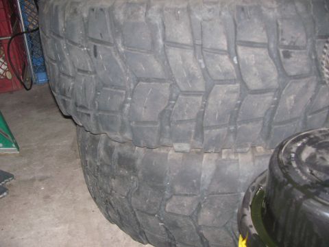 1968 Ford Mustang - A close-up view of two stacked off-road tires, showing their deep tread patterns.