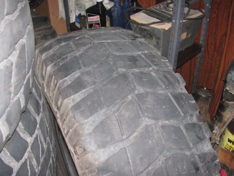 1968 Ford Mustang - Close-up of tire tread, with Motorcraft and Ford oil bottles visible on a shelf in the background.
