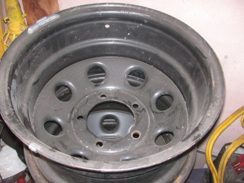 1968 Ford Mustang - A single black steel wheel rim is shown, with no visible markings to identify its make or year.