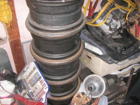1968 Ford Mustang - A stack of tires sits next to a yellow lamp and jumper cables, suggesting a garage or workshop setting.