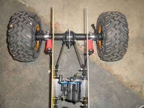 1994 Ford Escort - This is a close-up view of the chassis and drivetrain of a remote control car.