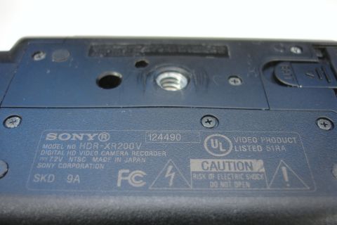 1993 Ford Taurus - Close-up of the label on a Sony HDR-XR200V digital HD video camera recorder, showing model and safety information.