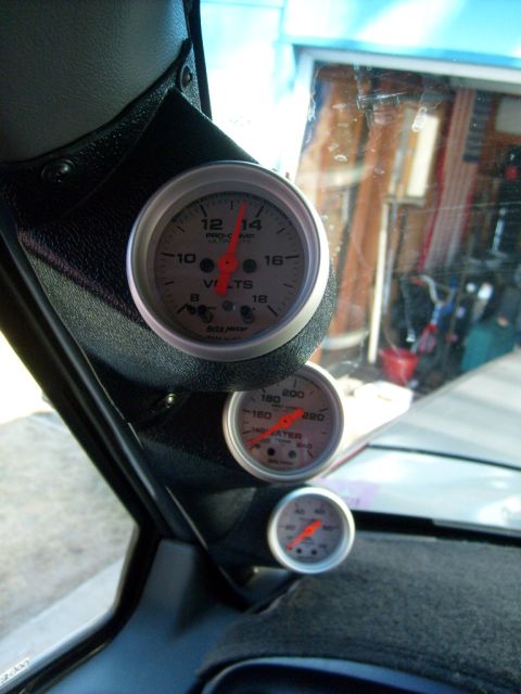 1986 Ford Bronco - Interior view of a vehicle's dashboard showing multiple gauges, including volts and water temperature.