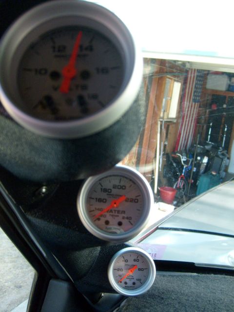 1986 Ford Bronco - Custom interior gauges for voltage, water temperature, and oil pressure are visible inside the vehicle.