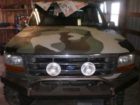 1995 Ford Bronco - This Ford truck is undergoing a camouflage paint job, with newspapers covering the windshield.