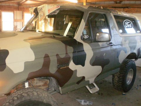 1995 Ford Bronco - This Ford Bronco has a custom camouflage paint job and appears to be modified for off-road use.