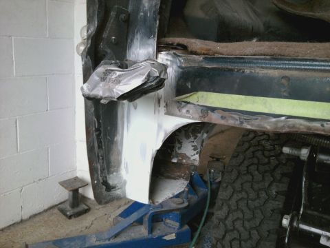 1994 Ford Bronco - Body panel repair in progress, with primer and tape visible on the metalwork.