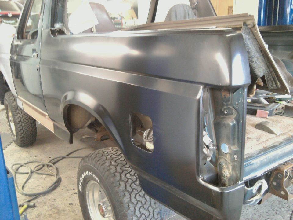 Dark gray Ford Bronco rear quarter panel, missing taillight assembly, undergoing repairs