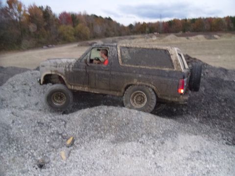 1985 Ford Bronco - Ford Bronco navigating a rough, rocky terrain during an off-road excursion.