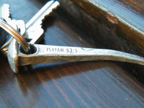 1982 Ford Bronco - A close-up shows keys and a metal object with a biblical reference engraved on it.
