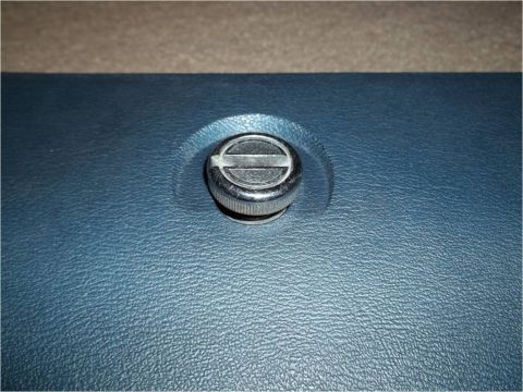 1972 Ford Ranchero - Close-up of a chrome knob set into a textured blue dashboard surface.