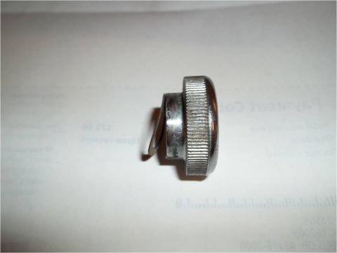 1972 Ford Ranchero - Close-up of a chrome knob with a ribbed edge and an attached metal clip, likely an interior car part.