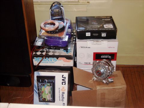 1979 Ford F-250 - A collection of car audio equipment, including speakers, wiring, and a JVC radio, alongside a car alternator.