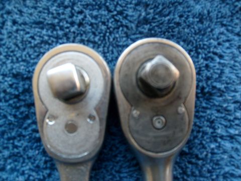 1986 Ford Bronco - Close-up of two ratchet wrenches on a blue textured surface.
