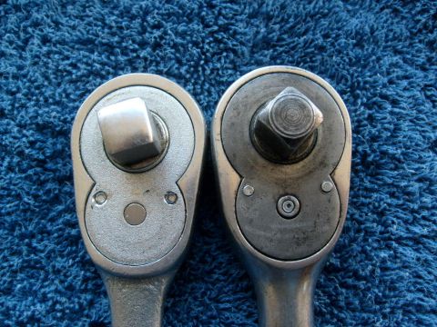 1986 Ford Bronco - Close-up view of two ratchet wrenches, highlighting their drive sockets against a blue background.