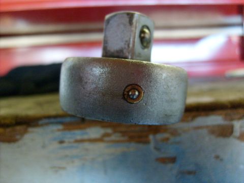 1986 Ford Bronco - A close-up view of a socket wrench head, showing the drive tang mechanism.
