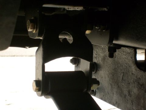 1986 Ford Bronco - This photo shows a close-up view of the suspension system of a vehicle, focusing on the mounting brackets and bolts.