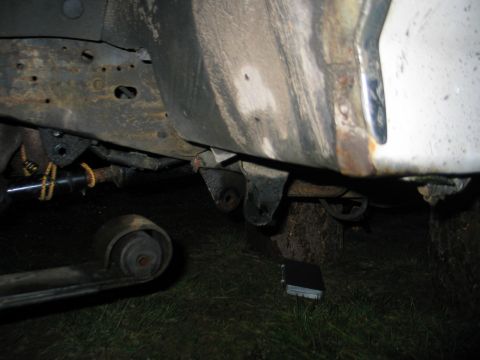 1984 Ford Bronco - Undercarriage view showing rusted frame and suspension components of a vehicle.