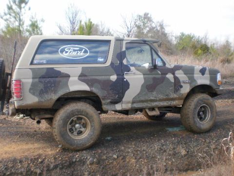 1995 Ford Bronco - This Ford Bronco is painted in a camouflage pattern and is seen off-road.