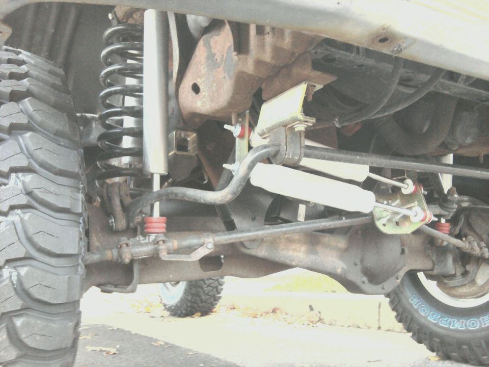 Front solid axle suspension with coil springs, dual steering stabilizers and red poly bushings