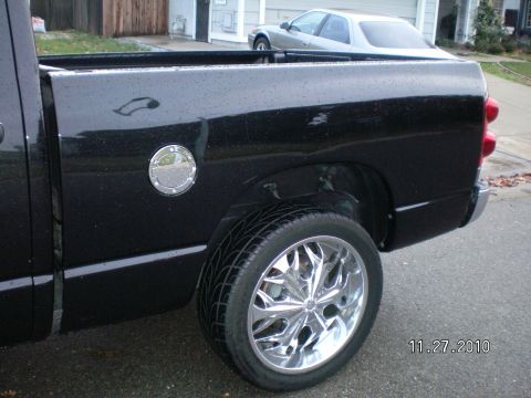 1996 Ford Bronco - A black pickup truck is shown from the rear quarter panel with custom chrome wheels.
