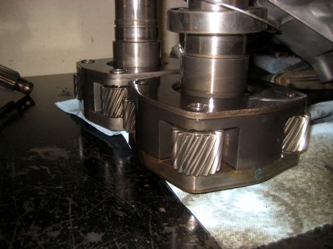 1996 Ford Bronco - Two transfer case gear assemblies with visible helical gears are shown on a workbench.