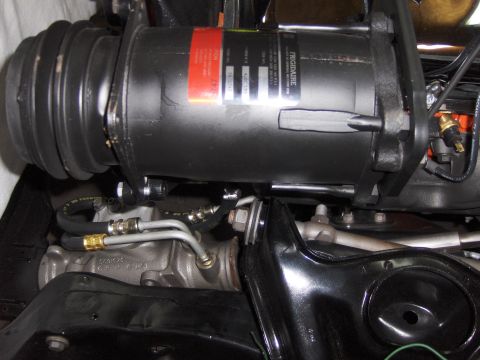 1970 Chevrolet Camaro - Close-up of an air conditioning compressor and associated plumbing, likely from an older vehicle.