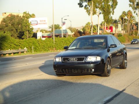 1995 Ford Taurus - A black Audi A6 sedan is seen driving on a highway during the day. Another vehicle is in the background.