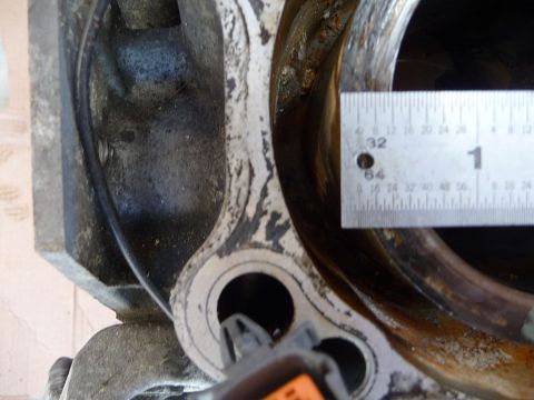 1993 Mazda MX-3 - Close-up of an engine cylinder bore being measured with a ruler, indicating its diameter.
