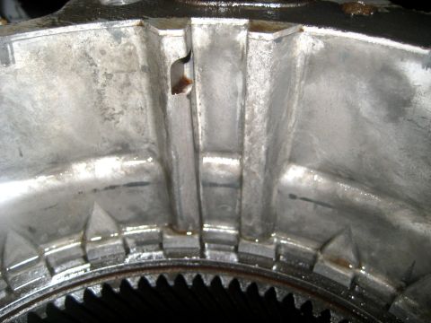 1996 Ford Bronco - Internal view of a metal transfer case housing, showing gears and casting marks.