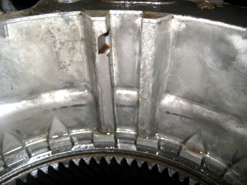 Close-up of a metal transfer case housing with internal gears visible