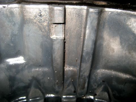 1996 Ford Bronco - This is a close-up view of a metal component, possibly from a vehicle's undercarriage.