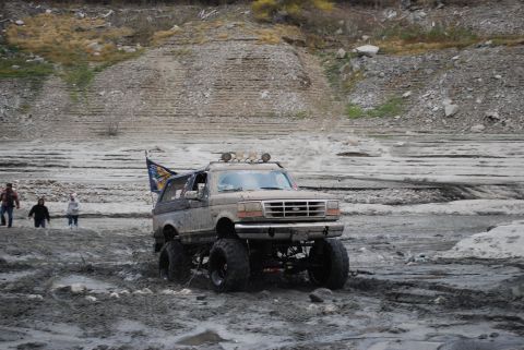 1996 Ford Bronco - Modified 1996 Ford Bronco tackling a muddy off-road course.