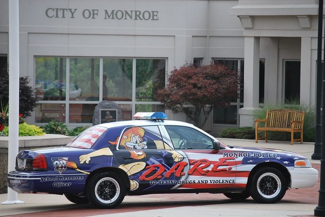 Side view of a police car with DARE graphics and cartoon characters