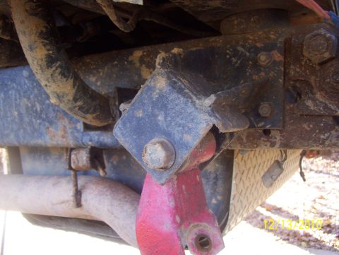 1978 Ford Bronco - Close-up view of a red suspension component and exhaust pipe, with a watermark indicating the photo was taken on 12/13/2010.