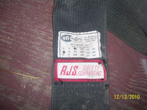 1978 Ford Bronco - Close-up of a seatbelt SFI Foundation and RJS Safety Equipment Inc. labels, indicating safety specifications.