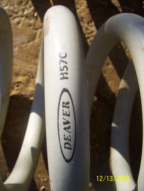 1978 Ford Bronco - A white Deaver coil spring with part number H57C is shown close up.