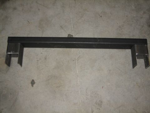 1984 Ford Bronco - A custom metal bracket is shown lying on a concrete surface, likely a garage floor.