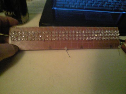 1989 Ford Bronco - A circuit board with multiple LEDs is being held, with a laptop and a can visible in the background.