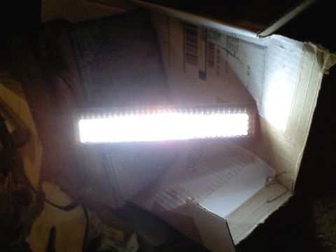 1990 Ford Bronco - An LED light bar is shown inside a cardboard box, emitting a bright light.