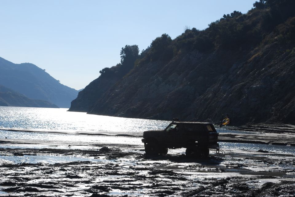 1996 Ford Bronco side view on muddy shore