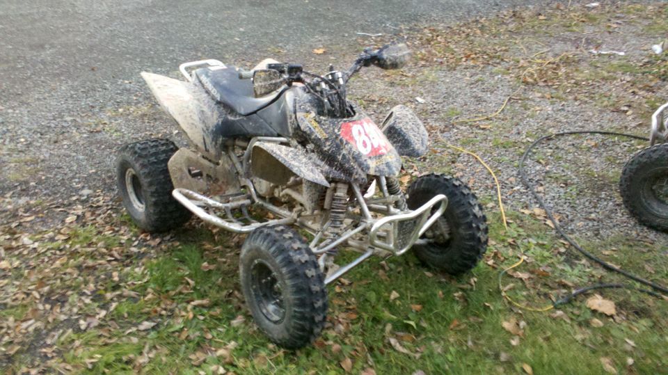 Muddy ATV with number 84 on the front. Another ATV is partially visible to the right
