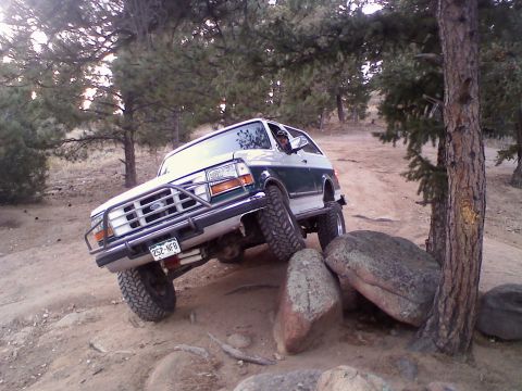 1996 Ford Bronco - This 1996 Ford Bronco is navigating a rocky obstacle on an off-road trail.