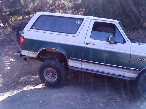 1996 Ford Bronco - This 1996 Ford Bronco is shown in a 3/4 front view, navigating a dirt trail.
