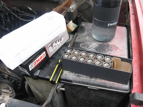 1981 Ford Bronco - An open Comp Cams box of twelve new valve springs or lifters sits on a black valve cover stamped with the Ford oval, staged in the engine b…